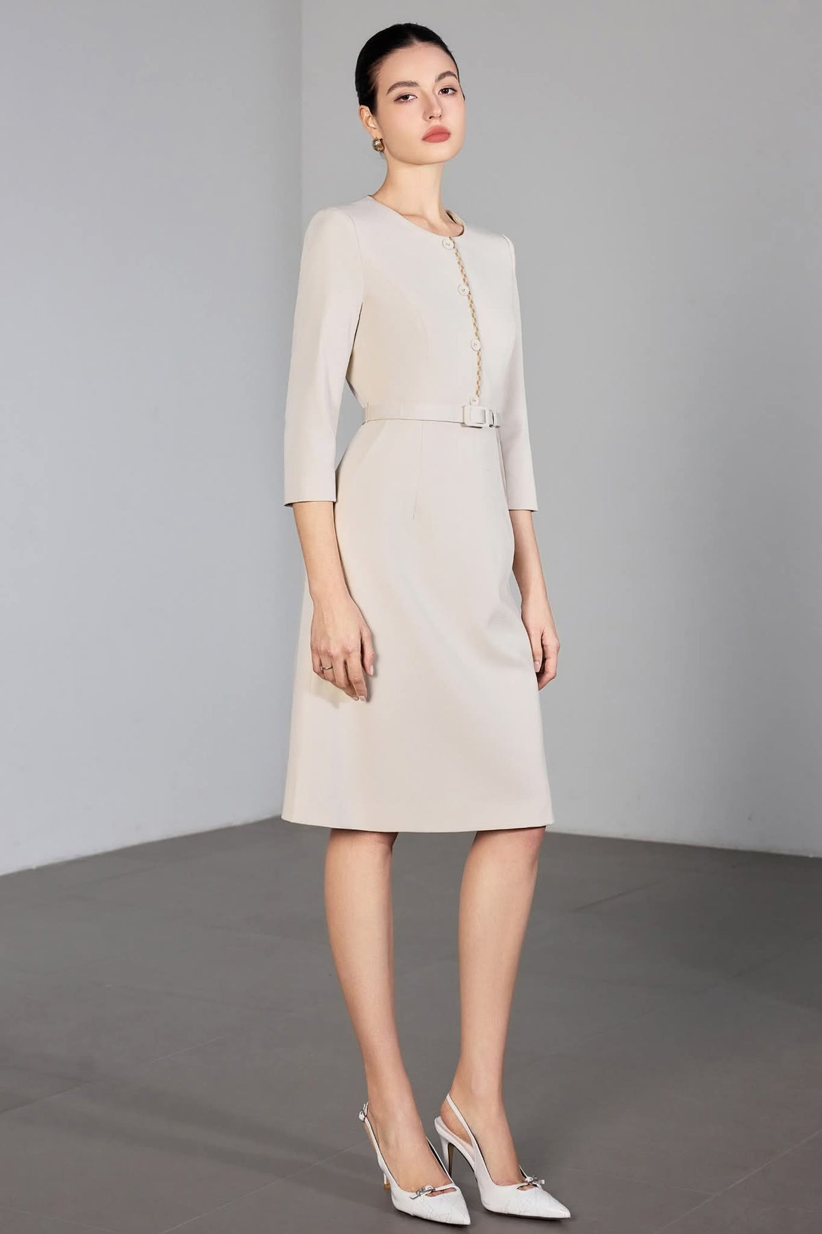 Ivory Poise Midi Dress Tailored Beige Dress with Gold Detail – another front view, worn by a model